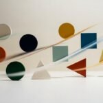 Projection mapping geometric patterns displayed on a clean white architectural wall with soft cinematic lighting.